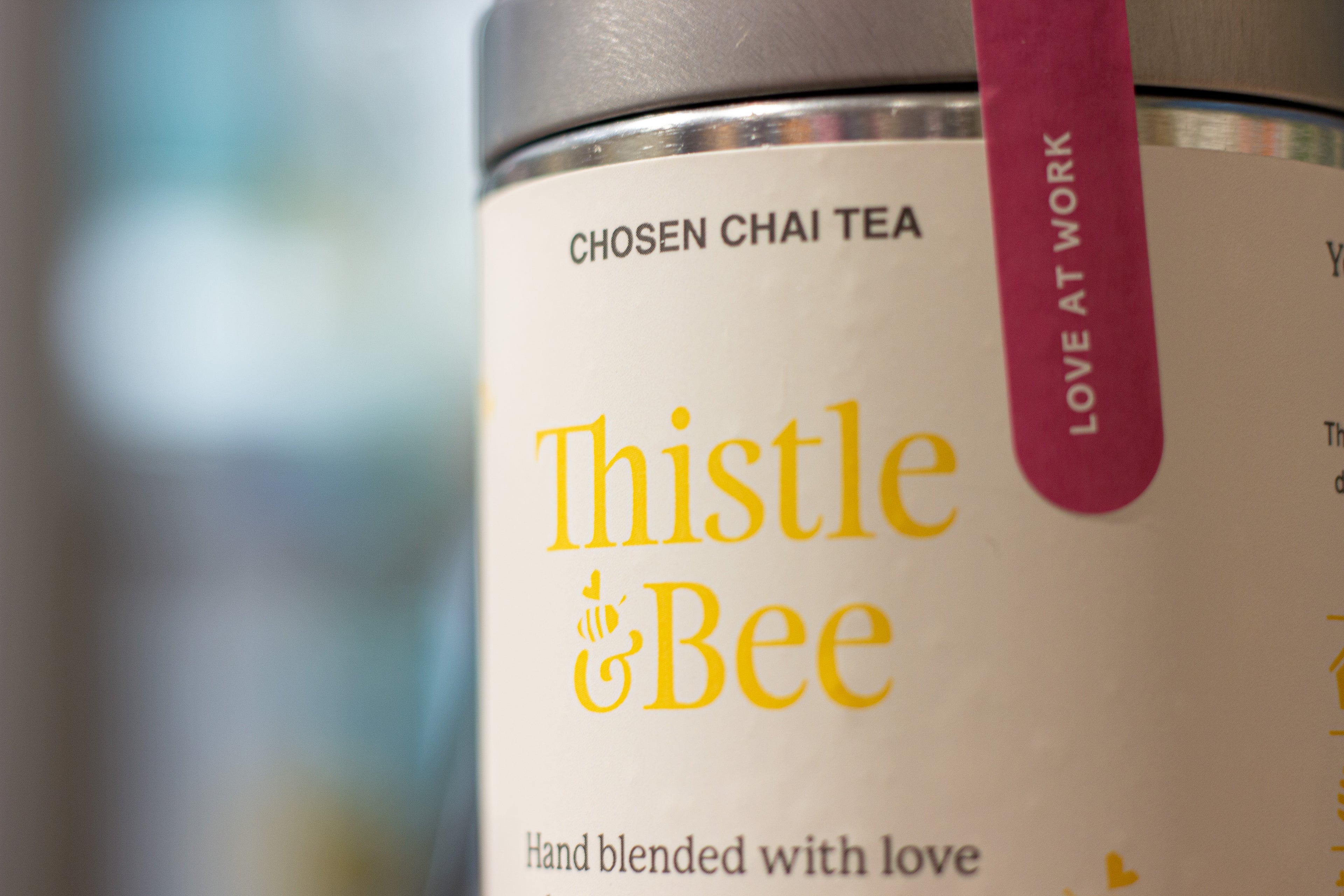 Thistle & Bee chai tea container with a blurred background